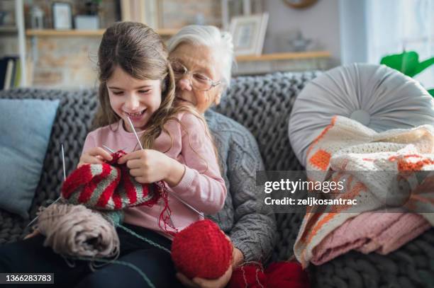 granny teach granddaughter knitting with needles - child knitting stock pictures, royalty-free photos & images