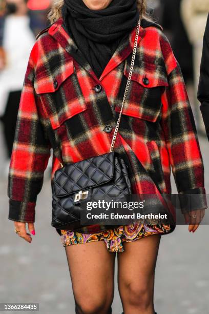 Guest wears a black wool scarf, a red and black checkered print pattern shirt, a black shiny leather quilted crossbody bag, a black with yellow /...
