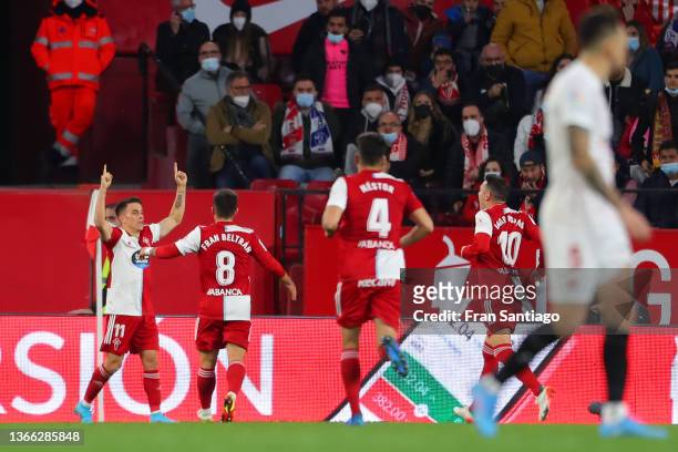 Franco Cervi of RC Celta de Vigo celebrates with teammates after scoring their team's first goal during the LaLiga Santander match between Sevilla FC...