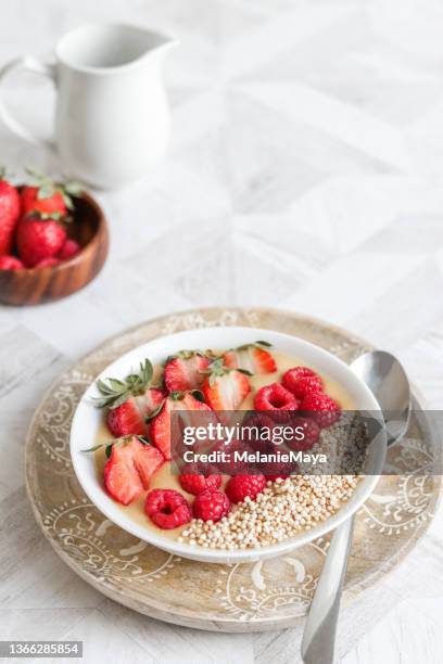 healthy vegan breakfast oats bowl with berries and puffed quinoa - quinoa meal stock pictures, royalty-free photos & images