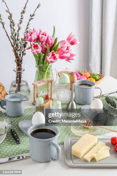 sunday breakfast table setting with eggs, coffee, butter and bread in germany - paasbrunch stockfoto's en -beelden
