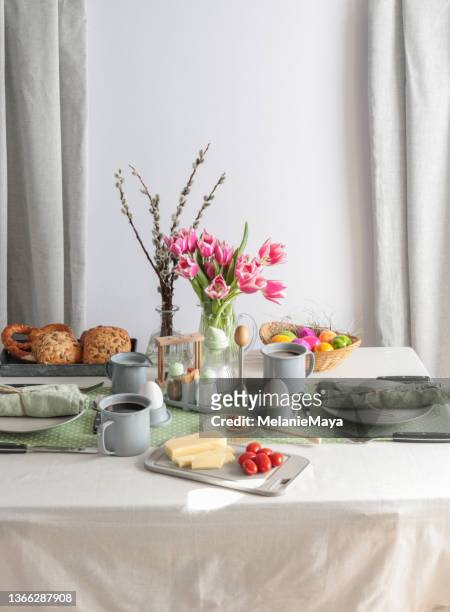 sunday breakfast table setting with eggs, coffee, butter and bread in germany - brunch stockfoto's en -beelden