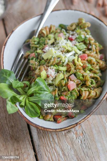 homemade spinach pasta with pesto and farmhouse bacon ham and corn salad - mache stock pictures, royalty-free photos & images