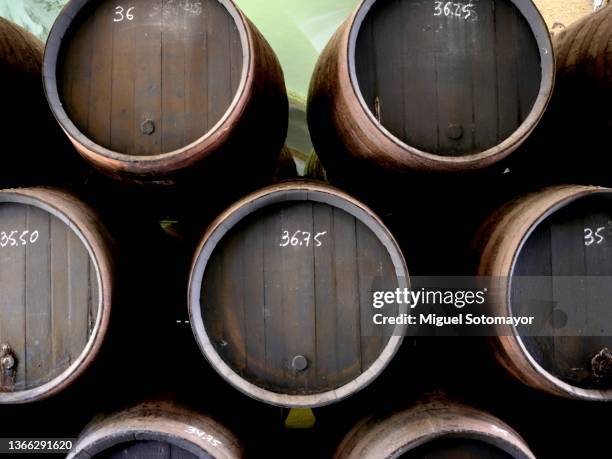 barrels with sherry wine in a cellar - sherry stock pictures, royalty-free photos & images