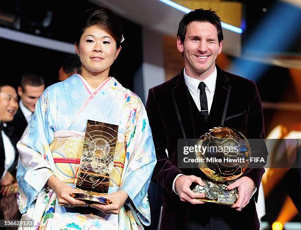 Ballon d'Or winner Lionel Messi and FIFA Women's World Player of the Year winner Homare Sawa of Japan pose with their trophies after the FIFA Ballon...