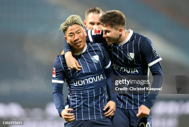 Takuma Asano of VfL Bochum celebrates with teammate Elvis Rexhbecaj after scoring their side's second goal during the Bundesliga match between VfL...