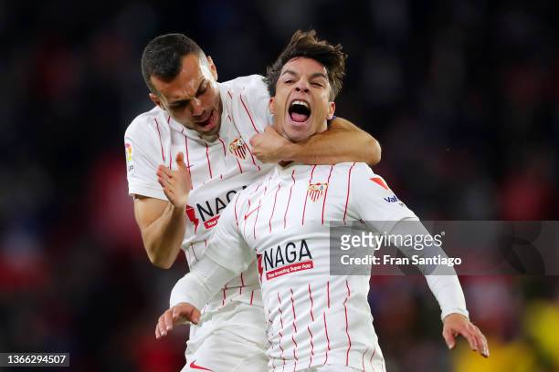 Oliver Torres of Sevilla FC celebrates with teammate Joan Jordan after scoring their team's second goal during the LaLiga Santander match between...