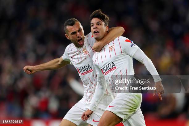 Oliver Torres of Sevilla FC celebrates with teammate Joan Jordan after scoring their team's second goal during the LaLiga Santander match between...