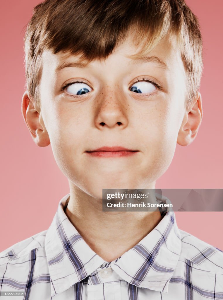 Portrait of young boy with funny face