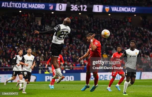 Renan Lodi of Atletico Madrid heads the ball under pressure from Dimitri Foulquier of Valencia CF during the LaLiga Santander match between Club...