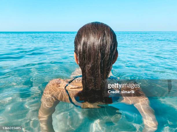 backview of woman in sea - older woman wet hair stock pictures, royalty-free photos & images