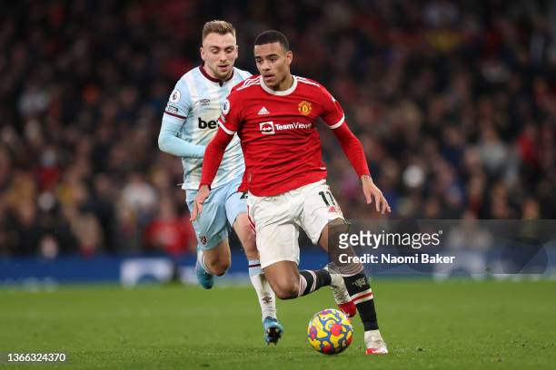 Mason Greenwood of Manchester United battles for possession with Jarrod Bowen of West Ham United during the Premier League match between Manchester...