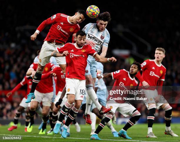 Cristiano Ronaldo of Manchester United and Bruno Fernandes of Manchester United battle for the ball in the air with Declan Rice of West Ham United...