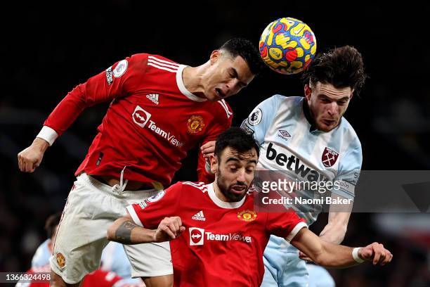 Cristiano Ronaldo of Manchester United and Bruno Fernandes of Manchester United battle for the ball in the air with Declan Rice of West Ham United...