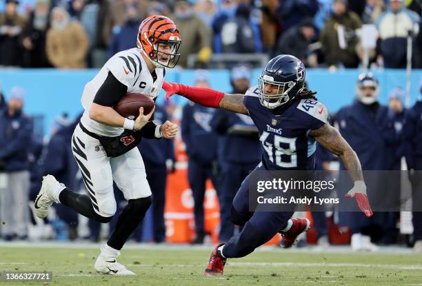 Quarterback Joe Burrow of the Cincinnati Bengals is tackled by outside linebacker Bud Dupree of the Tennessee Titans during the second quarter in the...