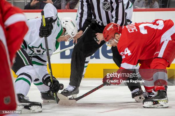 Pius Suter of the Detroit Red Wings faces off against Roope Hintz of the Dallas Stars during the second period of an NHL game at Little Caesars Arena...
