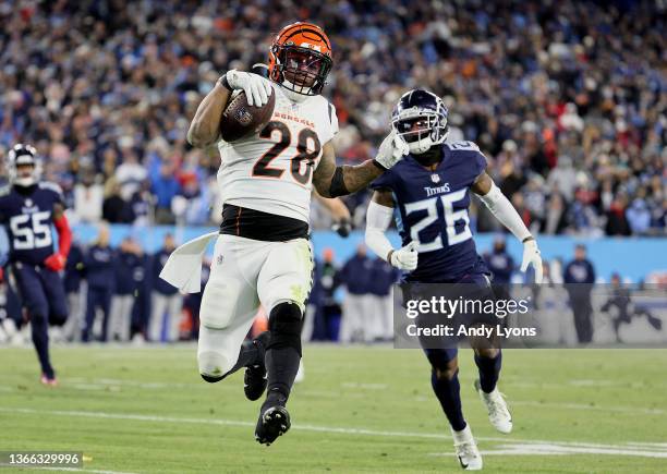Running back Joe Mixon of the Cincinnati Bengals rushes for a third quarter touchdown in front of cornerback Kristian Fulton of the Tennessee Titans...