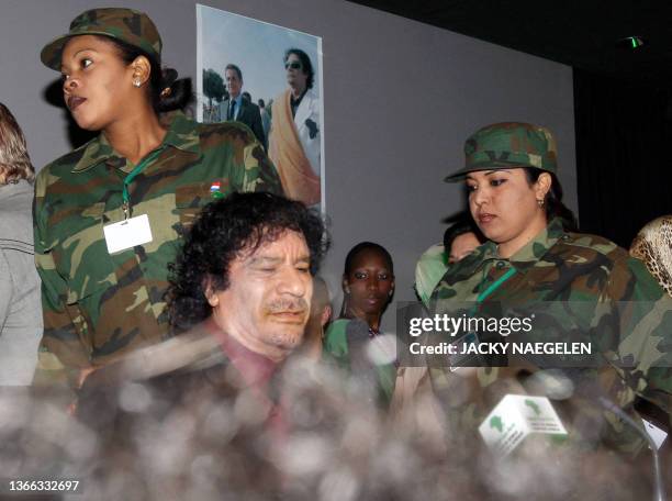 Libyan leader Moamer Kadhafi, surrounded by his female bodyguards, attends a meeting with female personalities, 12 December 2007 in Paris. AFP PHOTO...