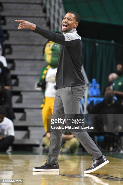 Head coach Kim English of the George Mason Patriots signals to his player sin the first half during a college basketball game against the Dayton...