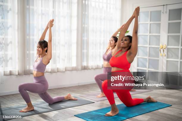 women are doing yoga exercises - human build stock pictures, royalty-free photos & images