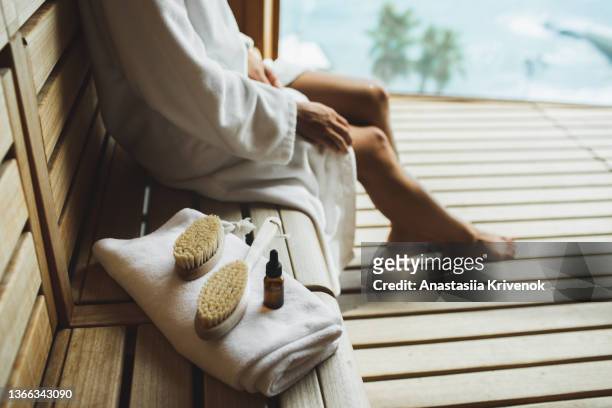 unrecognizable multiracial woman making anti cellulite or lymphatic thigh massage at sauna, closeup. - sauna ストックフォトと画像