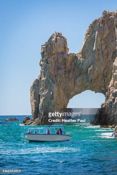 two tourist boats approach the famous landmark the arch or land's end in cabo san lucas, mexico - los cabos stock pictures, royalty-free photos & images