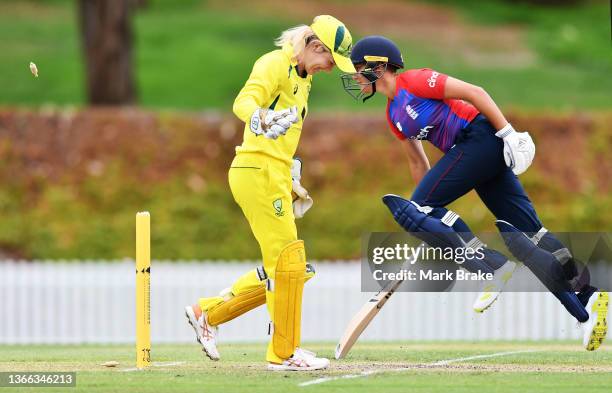 Issy Wong of England run-out by a direct hit from Ellyse Perry of Australia watched by Georgia Redmayne of Australia during the third match in the...