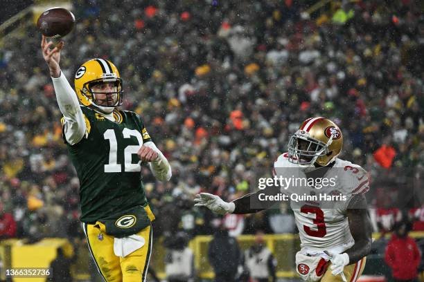 Quarterback Aaron Rodgers of the Green Bay Packers passes as safety Jaquiski Tartt of the San Francisco 49ers pursues during the 3rd quarter of the...