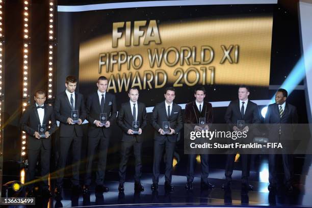 Dani Alves and Gerard Pique of Barcelona, Nemanja Vidic of Manchester United, Andres Iniesta, Xavi and Lionel Messi of Barcelona and Wayne Rooney of...