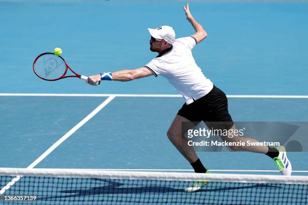 Jamie Murray of Great Britain plays a backhand in his third round doubles match against Simone Bolelli of Italy and Fabio Fognini of Italy during day...