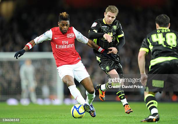 Alex Song of Arsenal holds off Adam Clayton of Leeds during the FA Cup Third Round match between Arsenal and Leeds United at Emirates Stadium on...