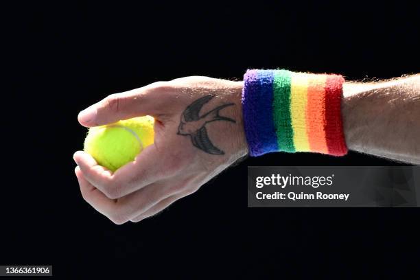 Detail of Thanasi Kokkinakis of Australia rainbow sweatband and tattoo in his third round doubles match against Ariel Behar of Uruguay and Gonzalo...