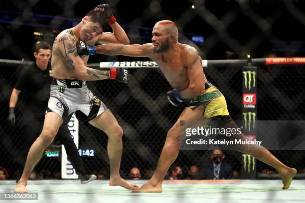 Deiveson Figueiredo of Brazil exchanges punches with Brandon Moreno of Mexico in their flyweight title fight during the UFC 270 event at Honda Center...