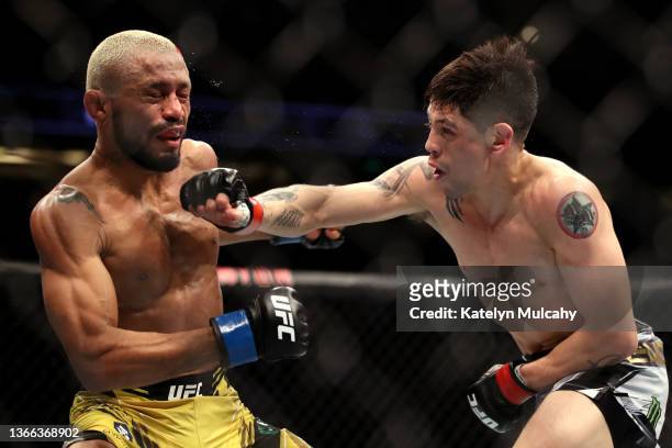 Brandon Moreno of Mexico punches Deiveson Figueiredo of Brazil in their flyweight title fight during the UFC 270 event at Honda Center on January 22,...