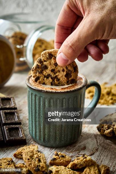 chocolate biscuits and a cup of cappuccino - dippen stock-fotos und bilder