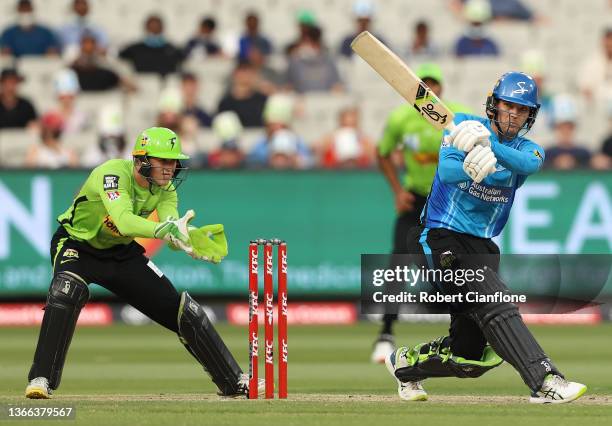 Alex Carey of the Strikers hits out during the Men's Big Bash League match between the Sydney Thunder and the Adelaide Strikers at Melbourne Cricket...