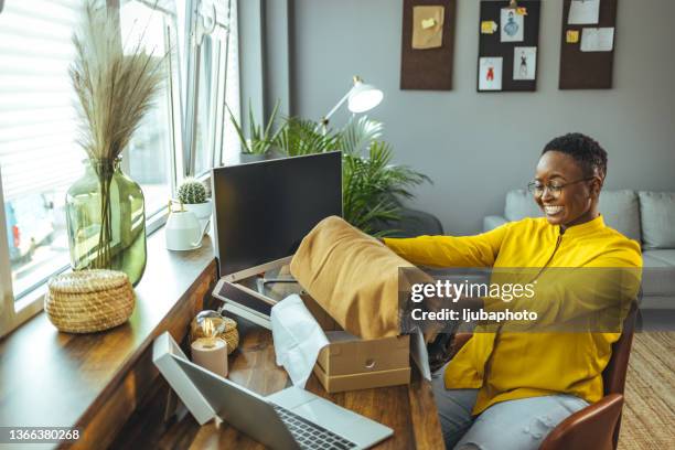 overjoyed young multi-racial girl received an online delivery order. attractive woman rejoicing while unpacking the box - opening delivery stock pictures, royalty-free photos & images