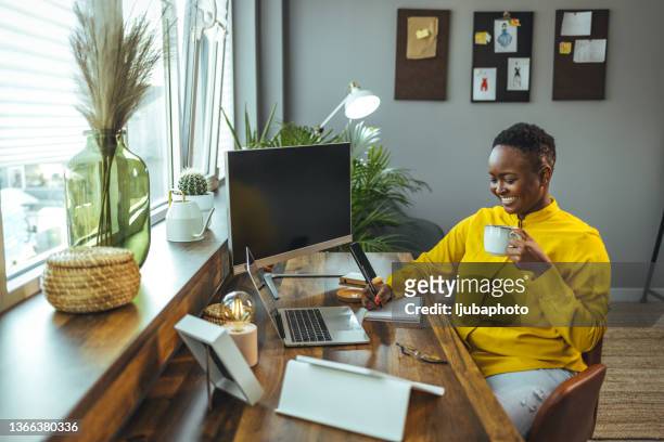 woman working from home, handwriting a document. - short hair for fat women stock pictures, royalty-free photos & images