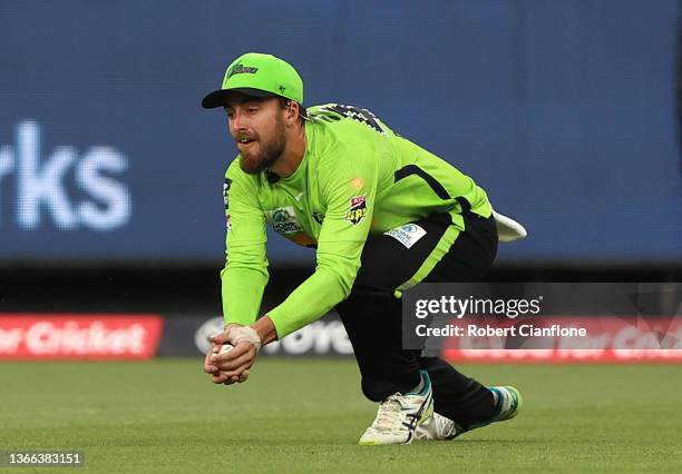 Alex Ross of the Thunder takes a catch to dismiss Travis Head of the Strikers during the Men's Big Bash League match between the Sydney Thunder and...