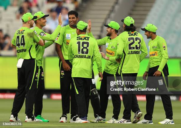 Gurinder Sandhu of the Thundercelebrates taking the wicket of Travis Head of the Strikers during the Men's Big Bash League match between the Sydney...