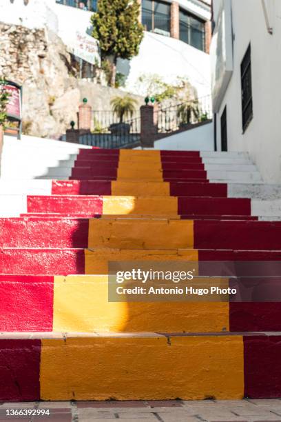 stairs painted with the colors of the spanish flag. - spanische flagge stock-fotos und bilder