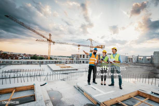 successful engineers having meeting on construction site - construction site 個照片及圖片檔