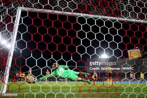 Ruben Neves of Wolverhampton Wanderers scores his team's second goal past Jonas Lossl of Brentford during the Premier League match between Brentford...