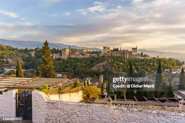 sunset over the famous granada old town with the alhambra - granada stock-fotos und bilder