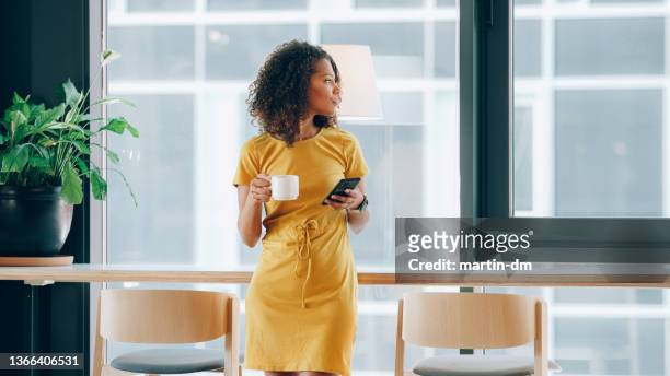 businesswoman in coworking space - business woman looking through window stock pictures, royalty-free photos & images
