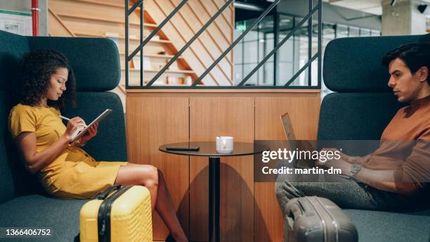 colleagues on business travel - airport departure area stockfoto's en -beelden