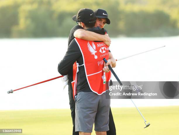 Thomas Pieters of Belgium celebrates with his caddie Adam Marrow on the eighteenth green after putting in to win the championship during the Final...