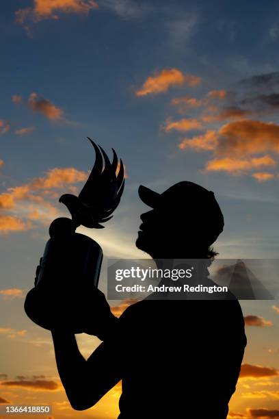 Silhouette as championship winner Thomas Pieters of Belgium poses with the trophy as he celebrates after winning the Final Round of the Abu Dhabi...