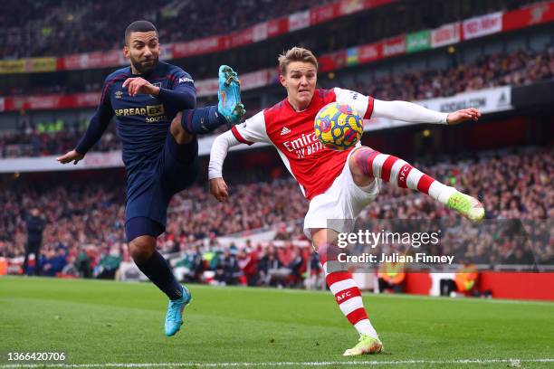 Martin Odegaard of Arsena battles for possession with Aaron Lennon of Burnley during the Premier League match between Arsenal and Burnley at Emirates...