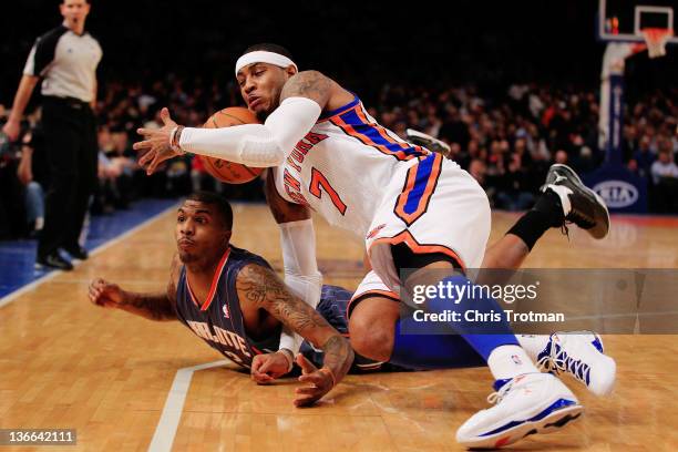 Carmelo Anthony of the New York Knicks competes for a loose ball with Tyrus Thomas of the Charlotte Bobcats at Madison Square Garden on January 9,...